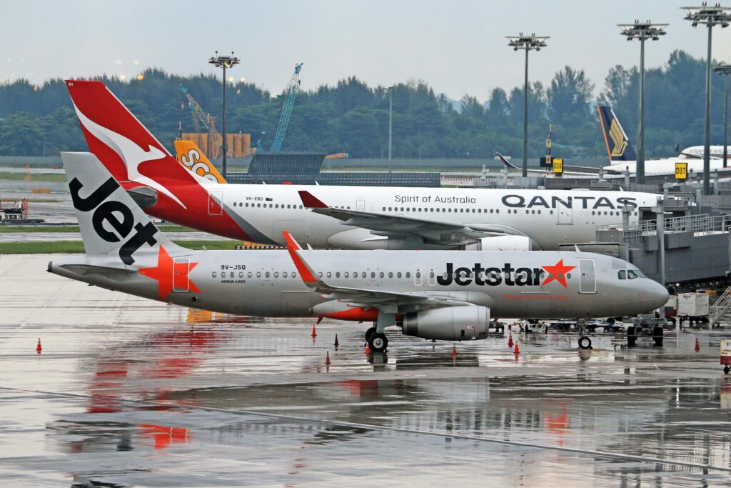 pexels-photo-20016302-20016302 Commercial airplanes from Jetstar and Qantas on runway, perfect for travel stock photos.