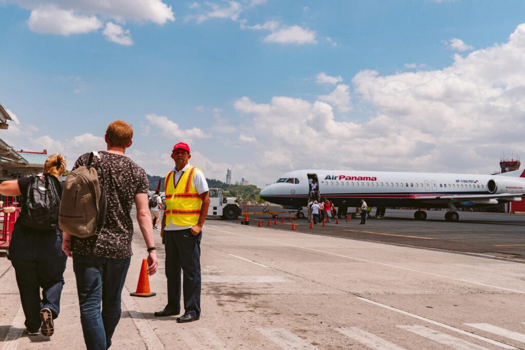 pexels-photo-2918138-2918138-1 Travelers are boarding an Air Panama aircraft at an airport on a clear, sunny day. Aviation activity captured.