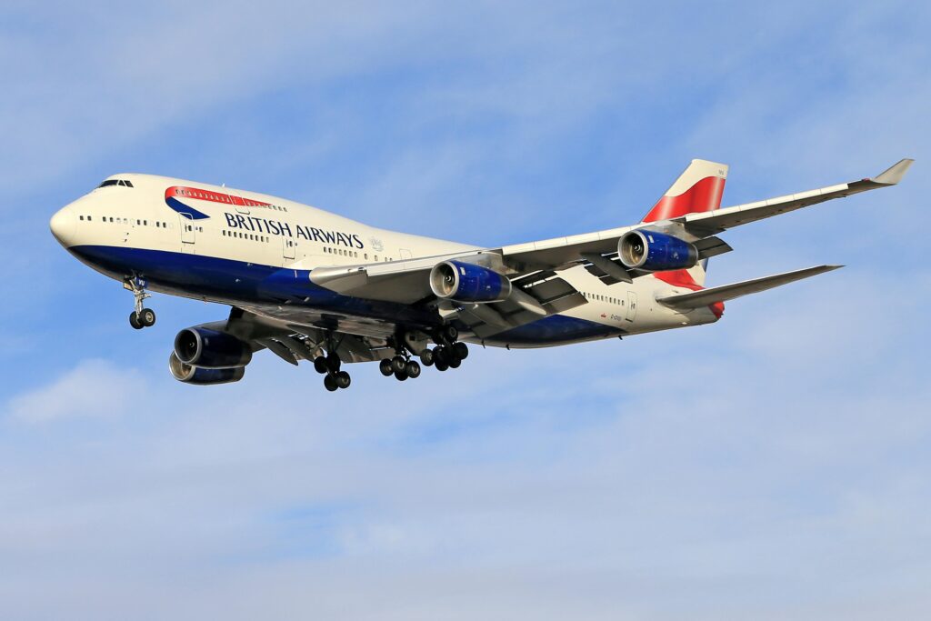 pexels-photo-9015530-9015530 A British Airways Boeing 747 aircraft flying against a blue sky.