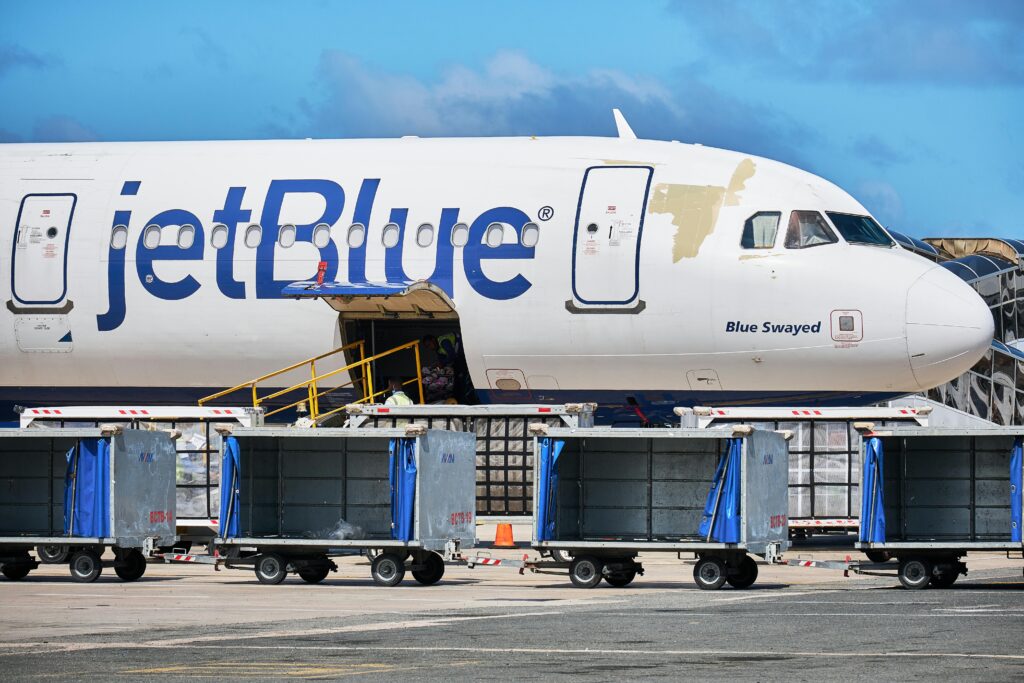 pexels-photo-9663804-9663804 JetBlue Airbus with luggage carts at Punta Cana Airport, Dominican Republic.